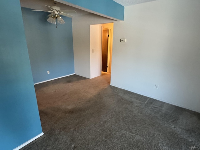 unfurnished room featuring ceiling fan and dark carpet