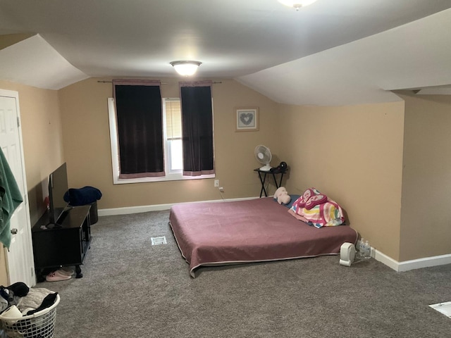 carpeted bedroom with lofted ceiling