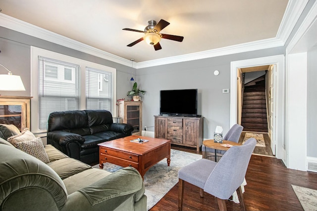 living room featuring crown molding, dark wood-type flooring, and ceiling fan