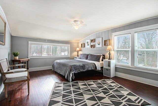 bedroom featuring multiple windows, vaulted ceiling, and dark hardwood / wood-style floors