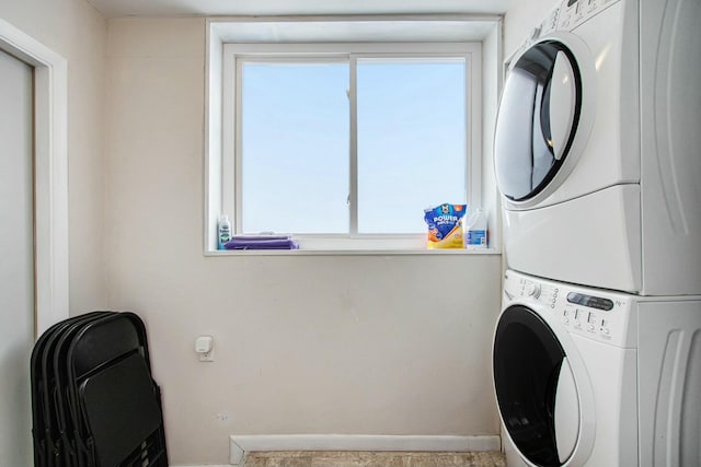 laundry area featuring stacked washer / dryer