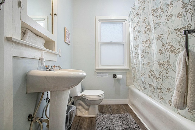 bathroom with hardwood / wood-style floors and toilet