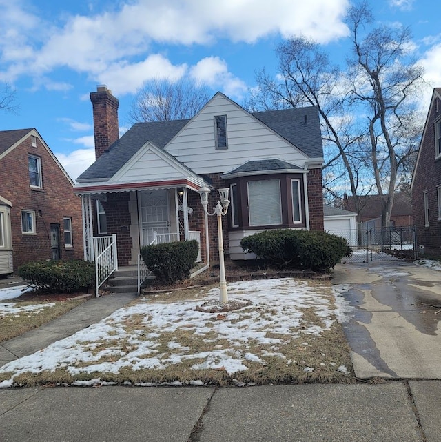 bungalow-style house featuring an outbuilding and a garage