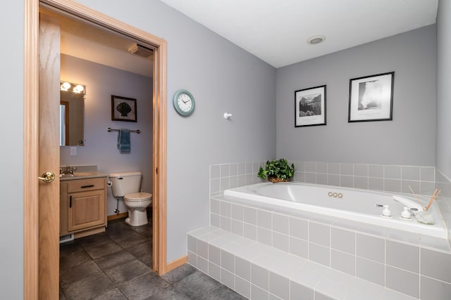 bathroom with visible vents, a garden tub, toilet, baseboards, and vanity