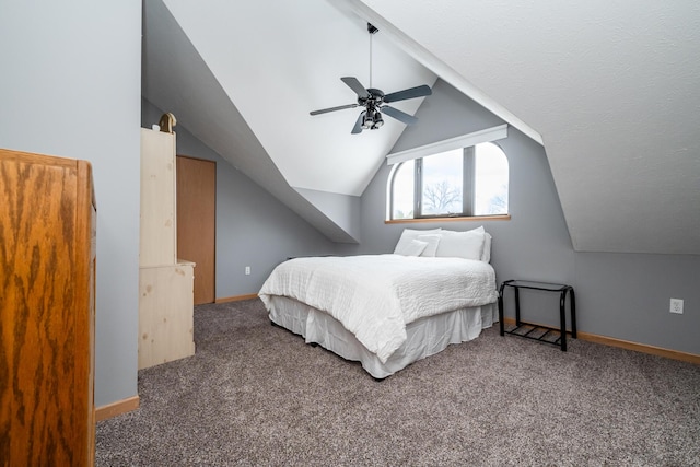 carpeted bedroom with baseboards, a ceiling fan, and vaulted ceiling