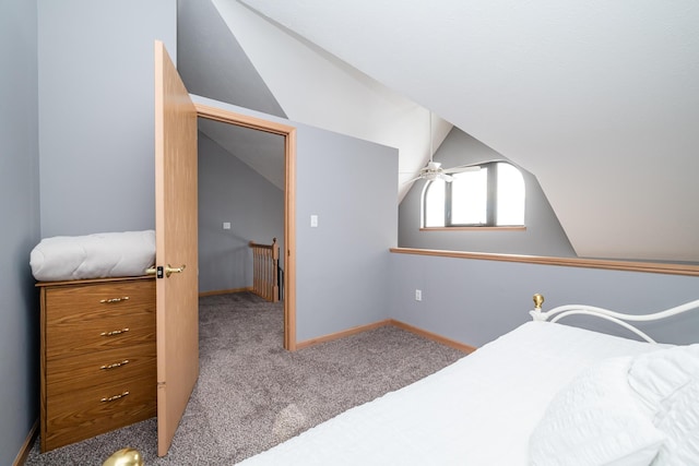 bedroom with vaulted ceiling, carpet flooring, and baseboards