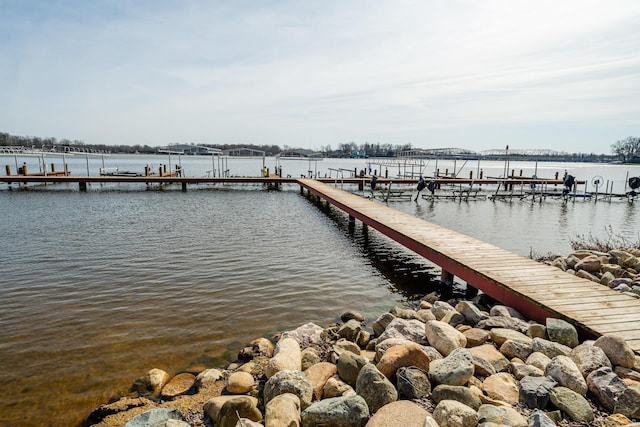 dock area with a water view and boat lift