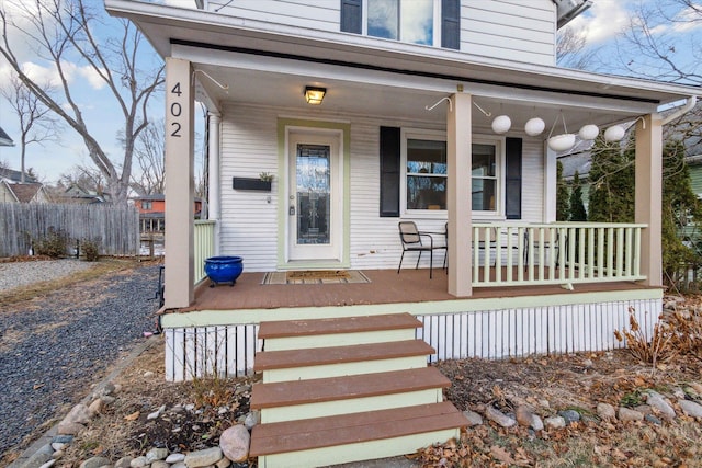 view of exterior entry with a porch