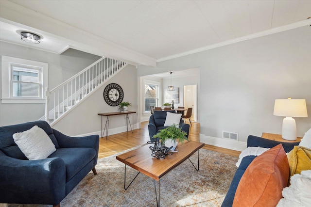 living room with hardwood / wood-style floors and ornamental molding