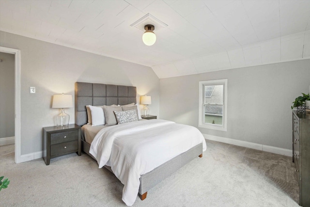 bedroom featuring vaulted ceiling and light colored carpet