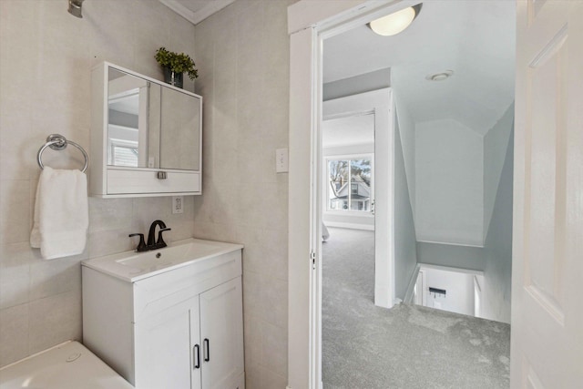 bathroom featuring vanity and tile walls