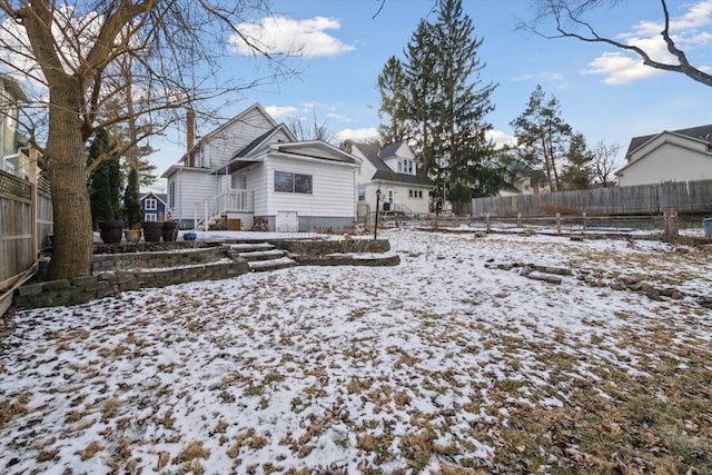 view of snow covered rear of property