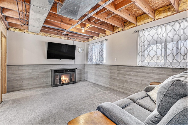 living room with carpet floors and wood walls