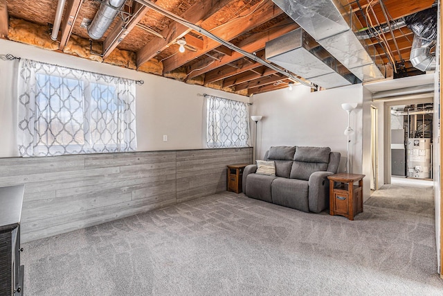 basement featuring gas water heater and carpet