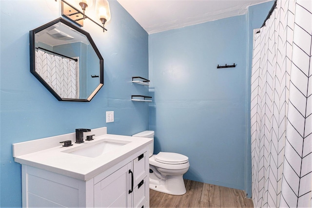 bathroom featuring vanity, hardwood / wood-style floors, walk in shower, and toilet