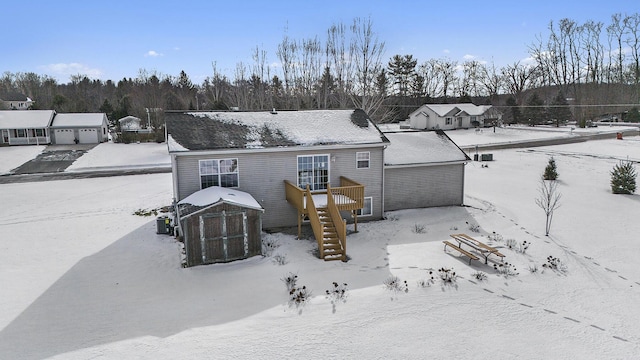 view of snow covered rear of property