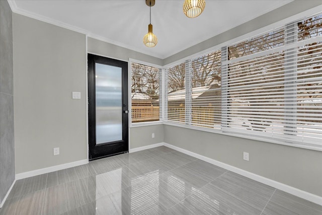 empty room featuring tile patterned floors and ornamental molding