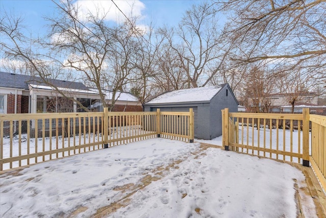 snow covered deck featuring a storage unit