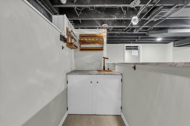 basement featuring light hardwood / wood-style floors