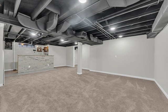 basement featuring carpet and bar area