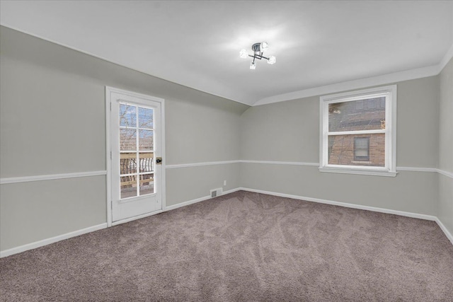 spare room with lofted ceiling and carpet flooring