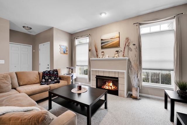 carpeted living room with a fireplace and a wealth of natural light