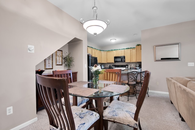 view of carpeted dining space