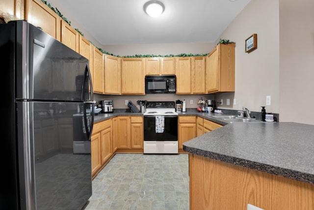 kitchen featuring light brown cabinetry, kitchen peninsula, sink, and black appliances