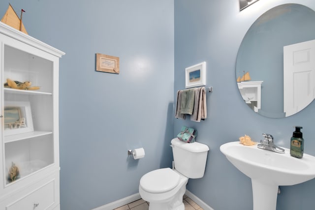 bathroom with tile patterned flooring and toilet