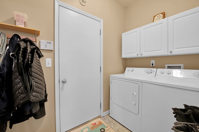 laundry area with separate washer and dryer and cabinets