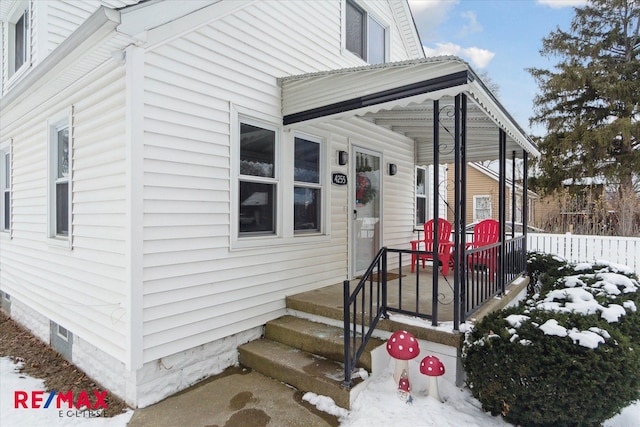 view of snow covered property entrance