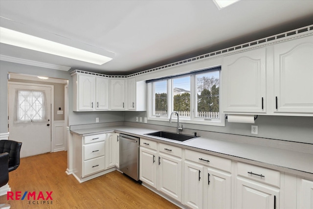 kitchen with white cabinetry, stainless steel dishwasher, sink, and light wood-type flooring