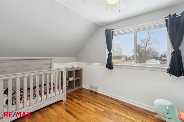 bedroom featuring lofted ceiling, hardwood / wood-style flooring, and ceiling fan