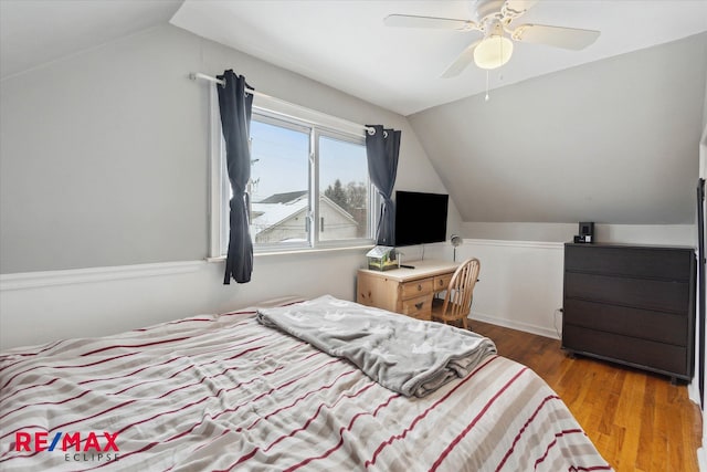 bedroom featuring hardwood / wood-style flooring, ceiling fan, and lofted ceiling