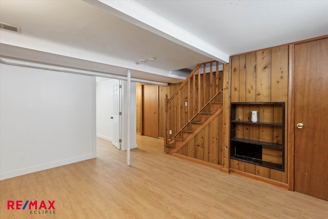 basement with hardwood / wood-style flooring