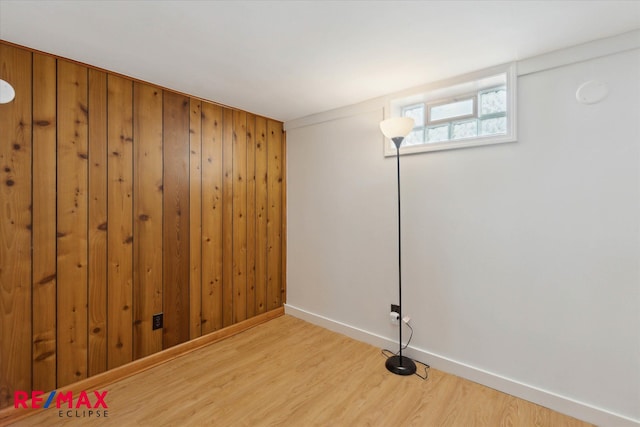 interior space with wooden walls and light wood-type flooring