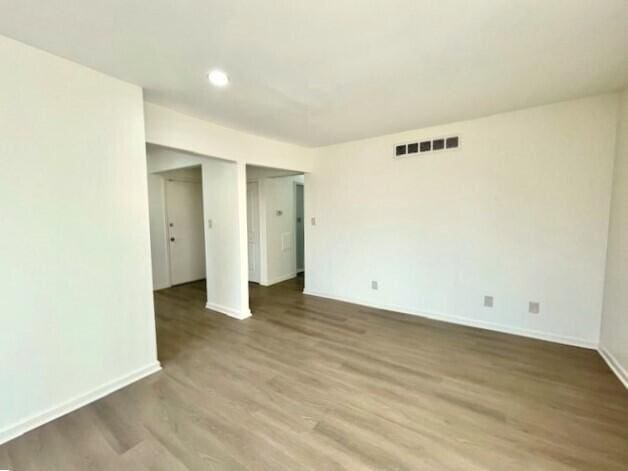 empty room with hardwood / wood-style flooring