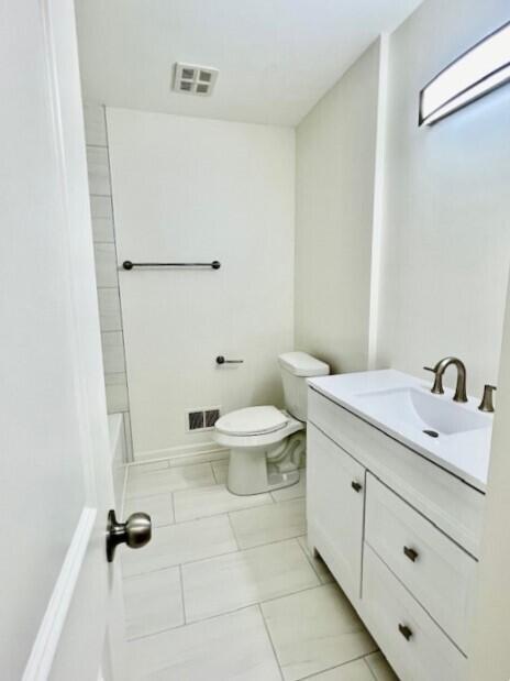 full bathroom featuring vanity, tile patterned flooring, bathtub / shower combination, and toilet