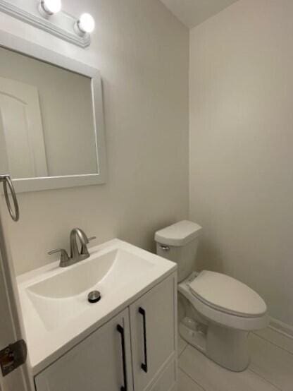 bathroom featuring tile patterned floors, toilet, and vanity