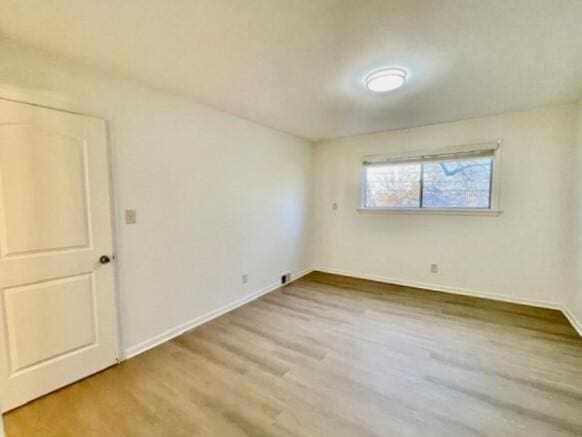 spare room featuring hardwood / wood-style flooring