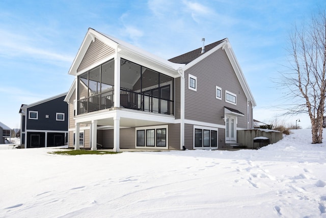 view of snow covered rear of property