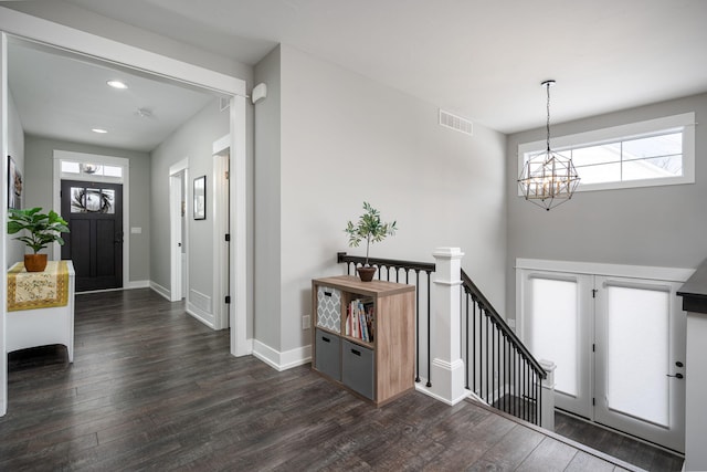 foyer featuring an inviting chandelier and dark hardwood / wood-style floors