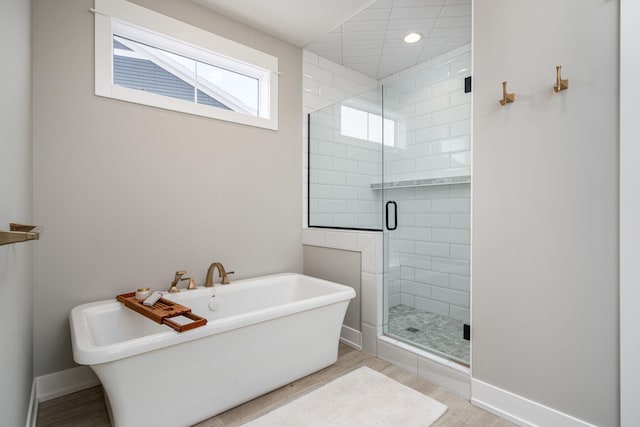 bathroom with shower with separate bathtub