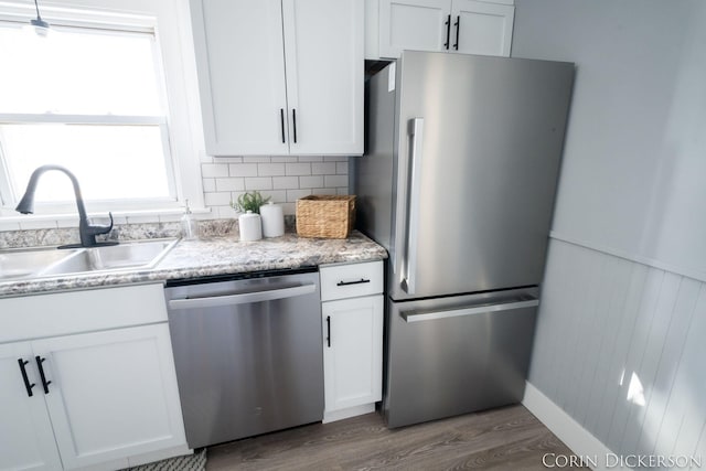 kitchen featuring sink, dark wood-type flooring, white cabinets, and appliances with stainless steel finishes