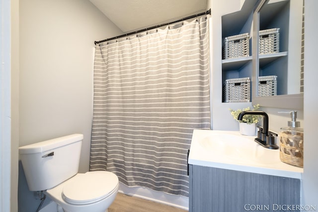 bathroom featuring vanity, hardwood / wood-style floors, walk in shower, and toilet