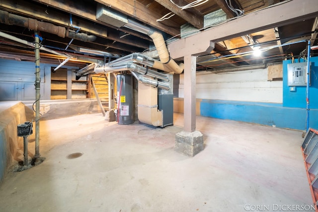 basement with heating unit, electric panel, and water heater