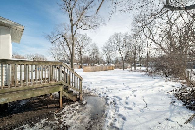 snowy yard with a wooden deck