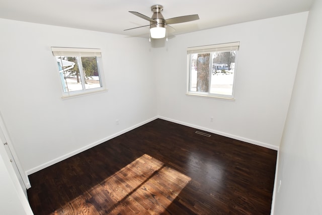 unfurnished room featuring ceiling fan, wood-type flooring, and a healthy amount of sunlight