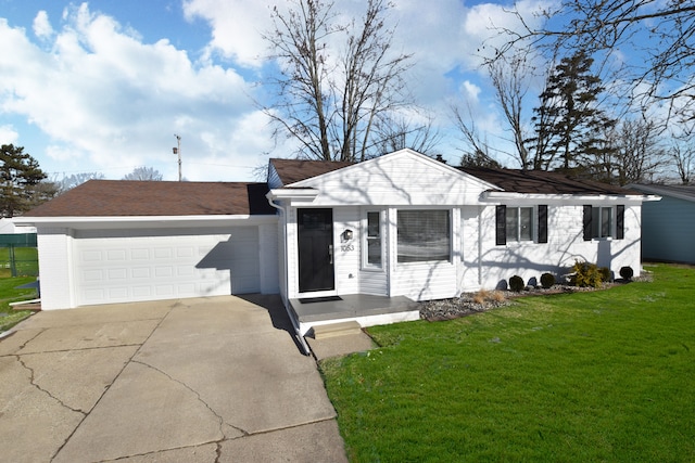 ranch-style house featuring a garage and a front lawn