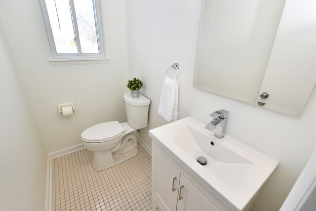 bathroom with tile patterned flooring, vanity, and toilet